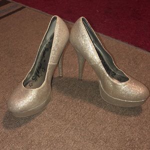A pair of sparkly glittery high-heeled pumps